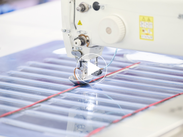 An automated sewing machine, overseen by experienced technicians.